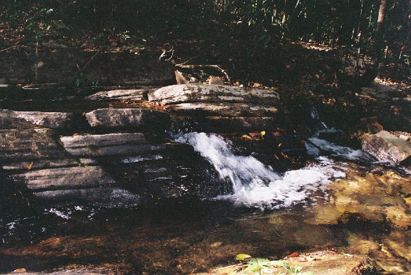 the water seems to be pouring from between the rock plates