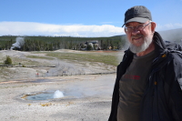 Guy next to a bubbling spring